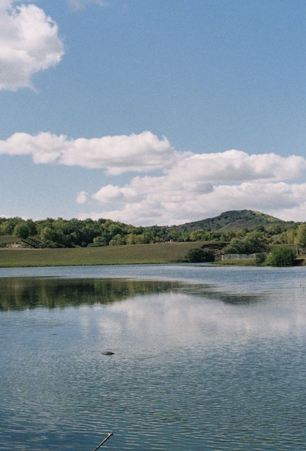 A calm lake under summer clouds